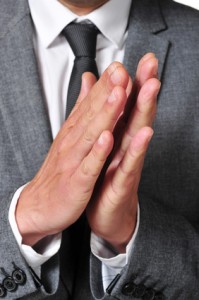 man in suit clapping his hands