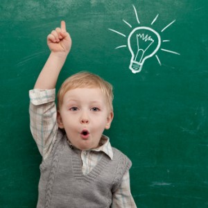 Cheerful smiling child at the blackboard.